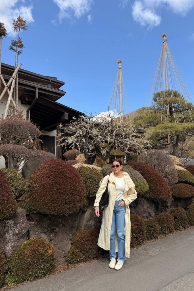 Cream Long Trench Coat + White Crewneck T Shirt + Light Wash Straight Leg Jeans + White Sneakers