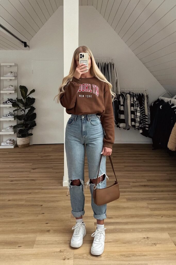 Cropped Brown Brooklyn Sweatshirt + Distressed High Waisted Mom Jeans + White Chunky Sneakers