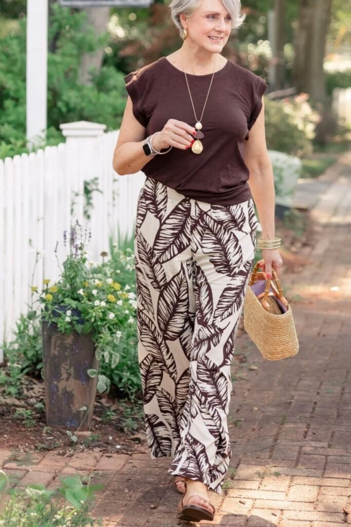 Dark Brown Flutter Sleeve Tee + Brown and White Tropical Leaf Print Wide Leg Pants + Tan Sandals