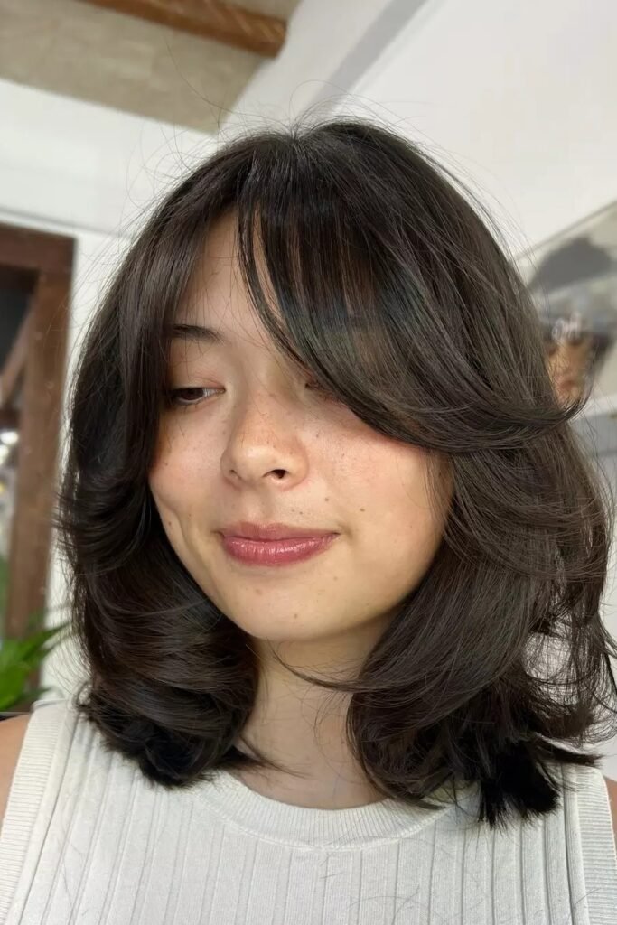 57. Dark Brunette Voluminous Lob with Curtain Bangs