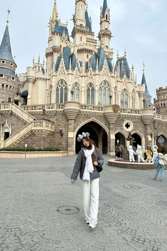 Dark Grey Puffer Jacket + White Scarf + White Wide Leg Sweatpants + Disney Ears Headband + White Sneakers