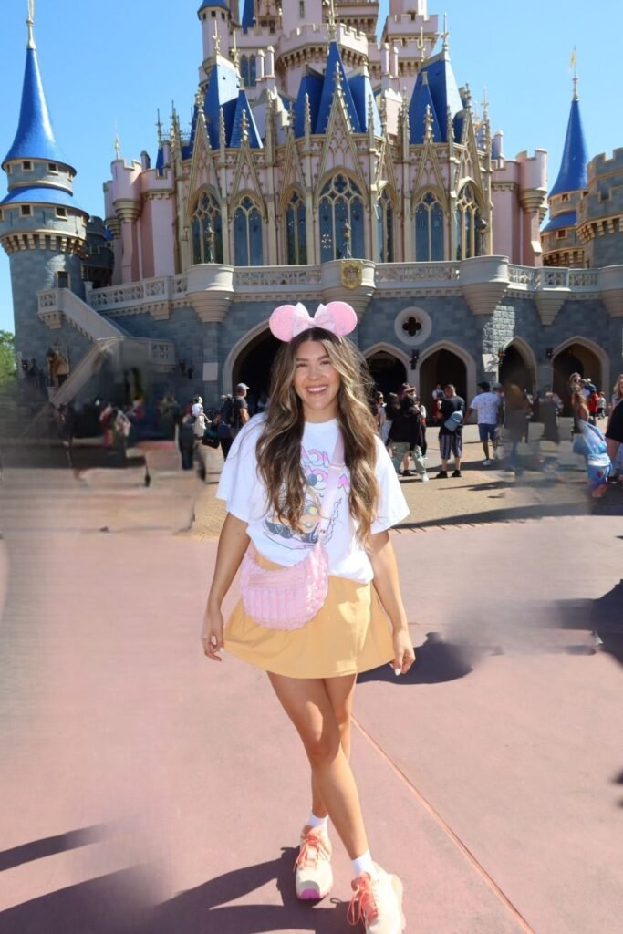 Disney Character Graphic Tee + Yellow Skater Skirt + Pink Crossbody Bag + Peach Sneakers