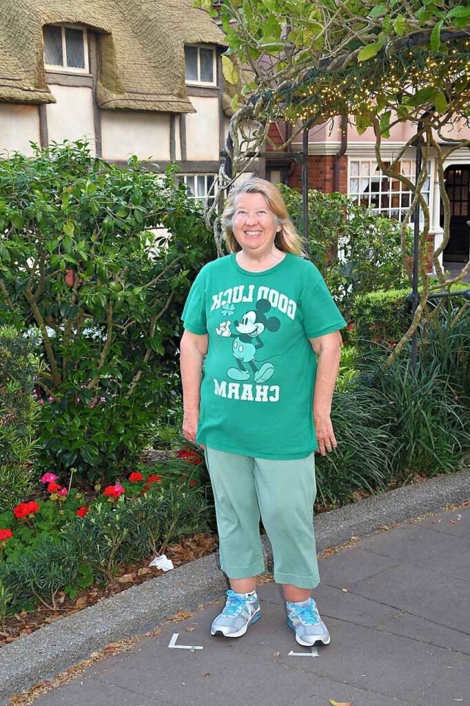 Green Graphic Mickey Mouse Tee + Light Green Cropped Sweatpants + Grey and Blue Running Shoes