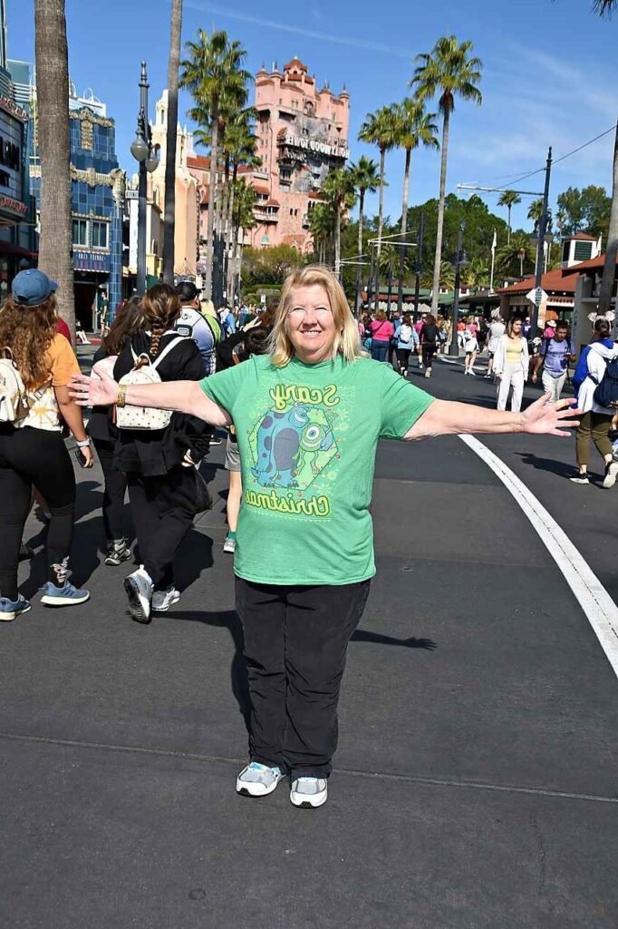 Green Graphic T Shirt + Black Straight Leg Pants + Grey and White Sneakers
