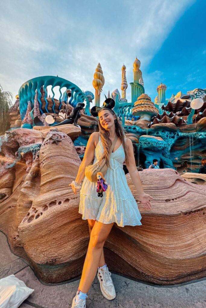 Light Blue Eyelet Mini Dress + Tan Crossbody Bag + White Athletic Sneakers + Disney Ear Headband