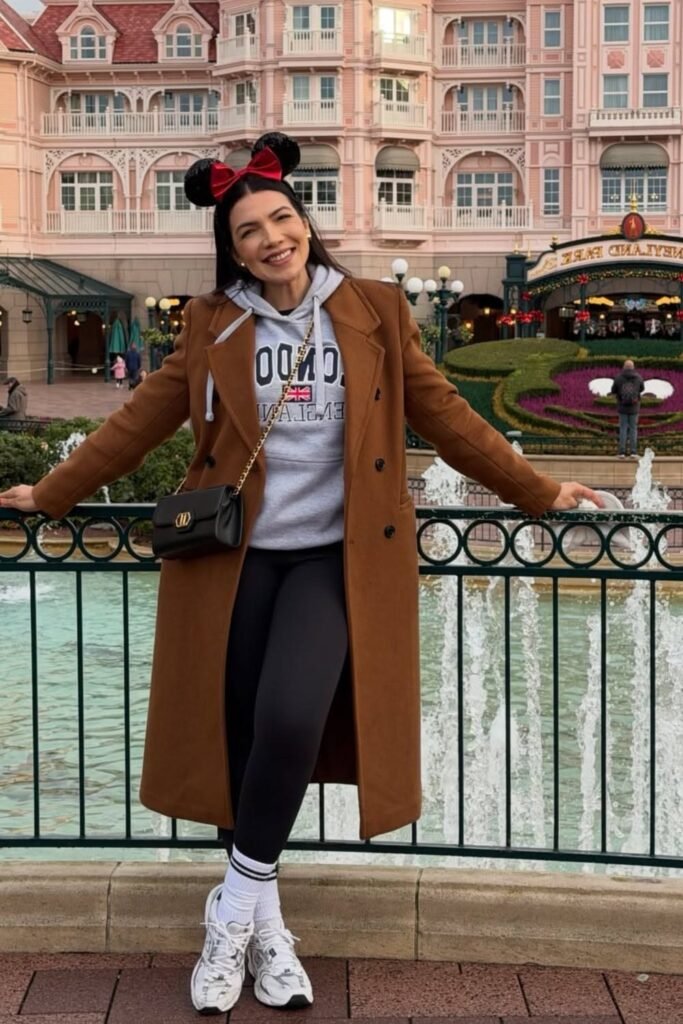 Long Brown Overcoat + Grey Graphic Hoodie + Black Leggings + White Athletic Sneakers
