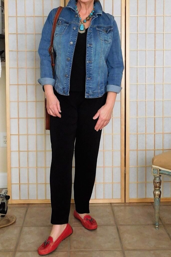 Medium Wash Denim Jacket + Black Top + Black Trousers + Turquoise Statement Necklace + Red Loafers