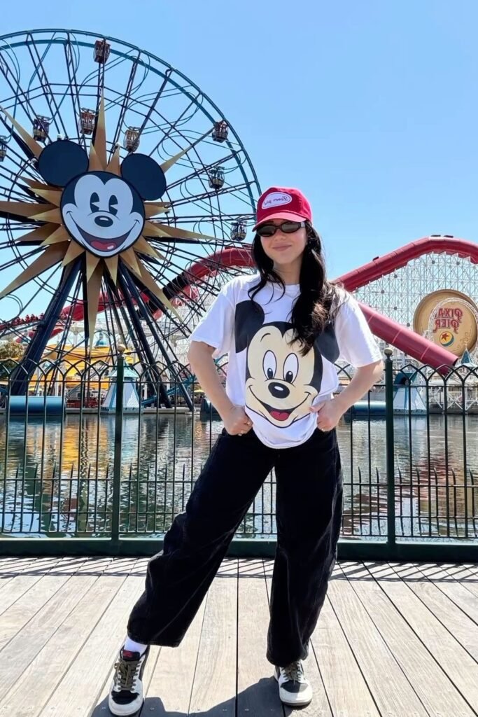 Mickey Mouse Graphic Tee + Black Baggy Jeans + Red Baseball Cap + Black and White Sneakers
