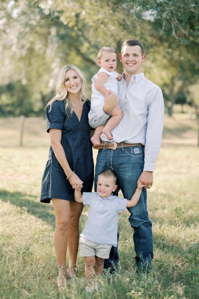 Navy Blue Dress + Tan Sandals (Mother) / Light Blue Button Down Shirt + Dark Wash Jeans + Brown Belt (Father) / White Tank + White Shorts (Baby) / Striped Polo + Khaki Shorts + White Sneakers (Son)