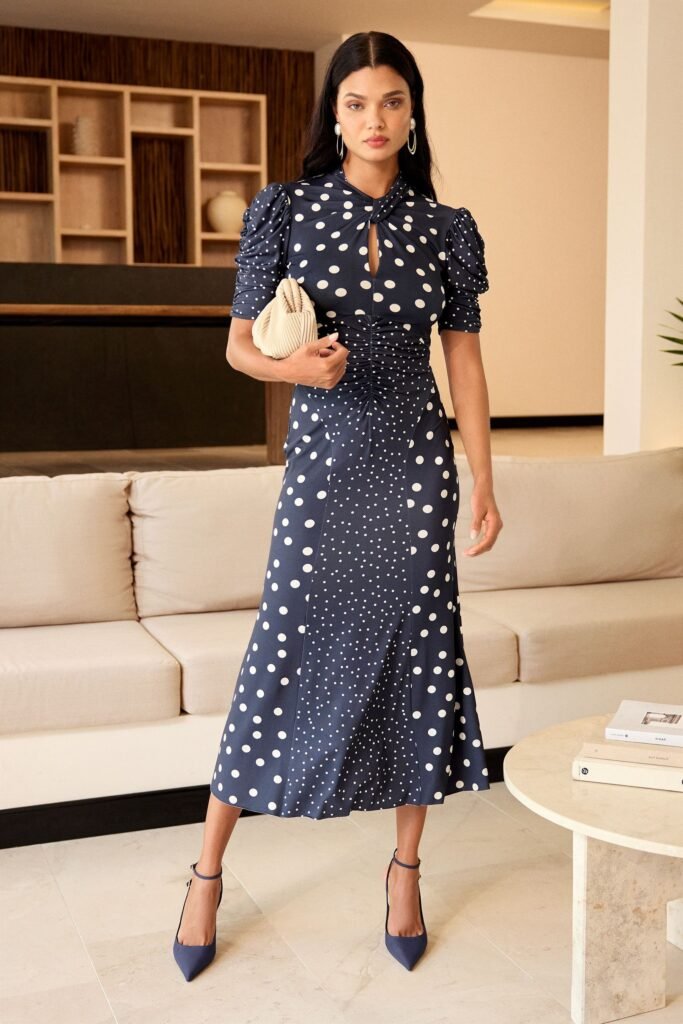 Navy Polka Dot Ruched Midi Dress + Puff Sleeves + Navy Pointed Toe Heels + Beige Ruched Clutch
