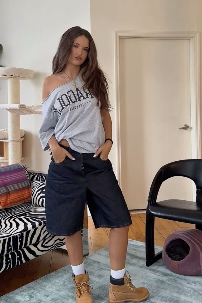 Off-the-Shoulder Graphic Tee + Dark Wash Denim Bermuda Shorts + Tan Work Boots