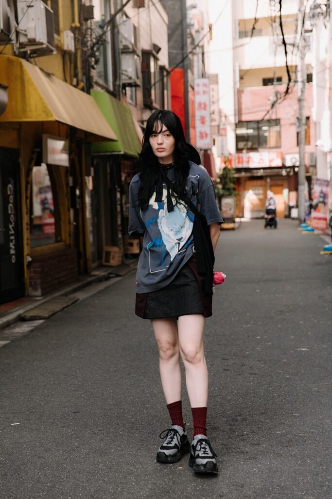 Oversized Anime Graphic T Shirt + Black Structured Mini Skirt + Burgundy Crew Socks + Black & Grey Athletic Sneakers