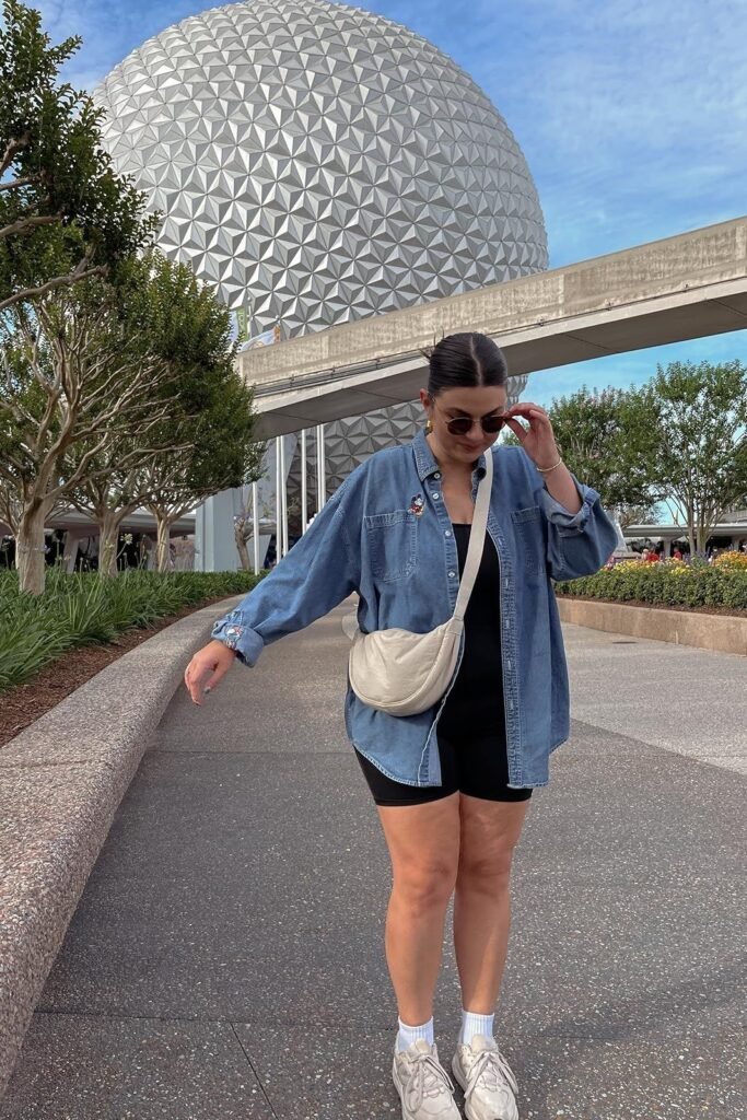 Oversized Denim Button Down + Black Bodysuit + Black Biker Shorts + White Sneakers + Beige Crescent Bag