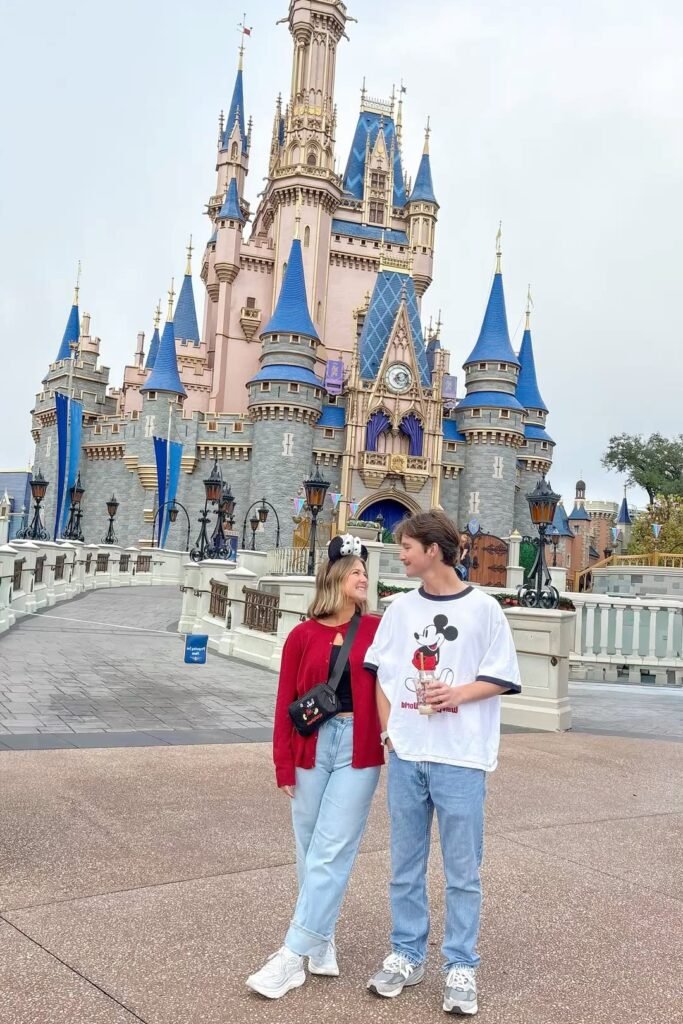 Oversized Mickey T Shirt / Red Cardigan + Light Blue Wide Leg Jeans + White Sneakers / Grey Athletic Sneakers