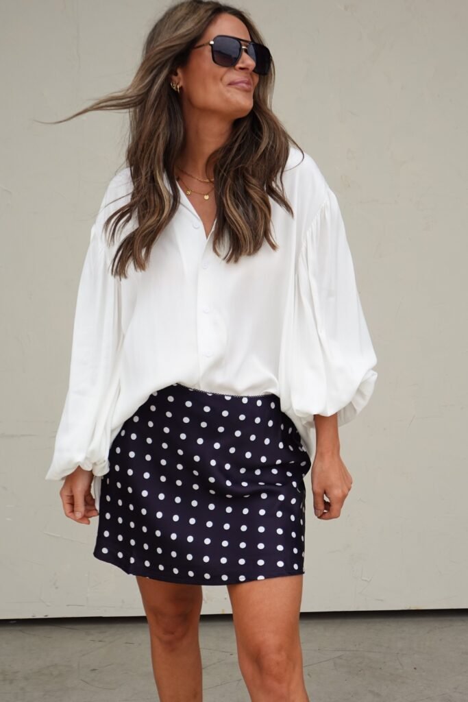 Oversized White Button-Down + Navy Polka Dot Silk Skirt + Black Aviator Sunglasses