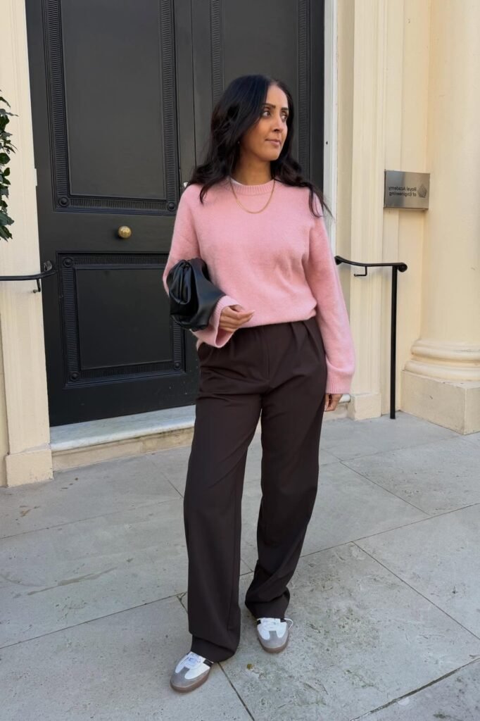 Pastel Pink Crewneck Sweater + Dark Brown Trousers + Grey and White Retro Sneakers