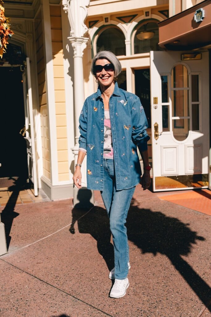 Pink Graphic Tee + Embroidered Denim Button Down + Slim Fit Blue Jeans + White Sneakers