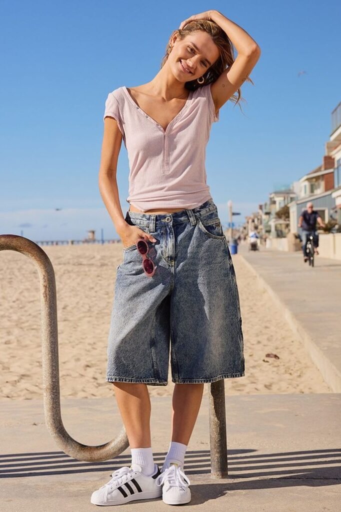 Pink Henley Tee + Distressed Denim Jorts + White Shell-Toe Sneakers