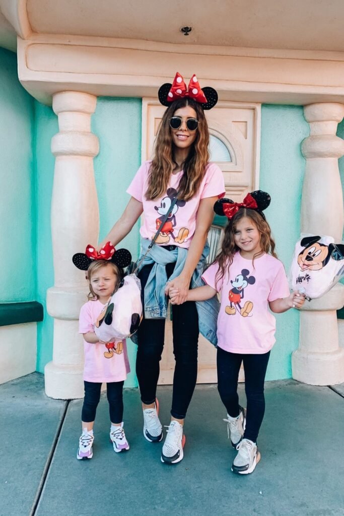 Pink Mickey Mouse Graphic T Shirt + Black Skinny Jeans + White and Black Sneakers