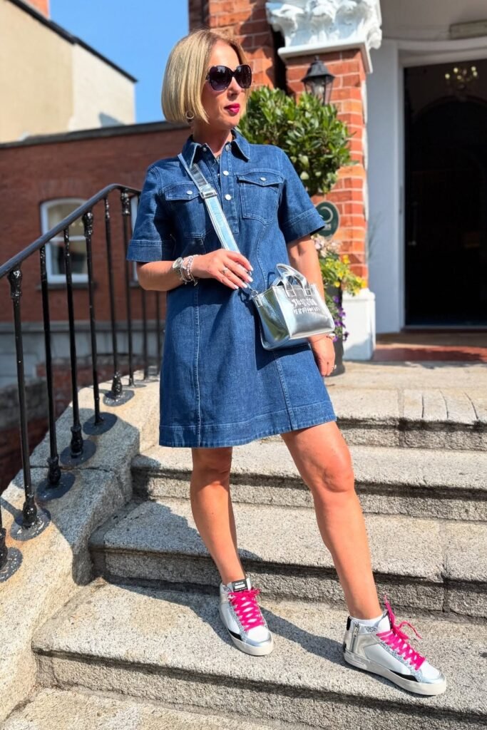 Short Sleeve Denim Shirt Dress + Silver Metallic Crossbody Bag + White High Top Sneakers with Pink Laces