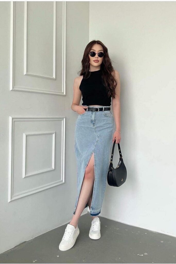 Sleeveless Black Crop Top + Light Wash Denim Maxi Skirt with Front Slit + Black Belt + White Sneakers