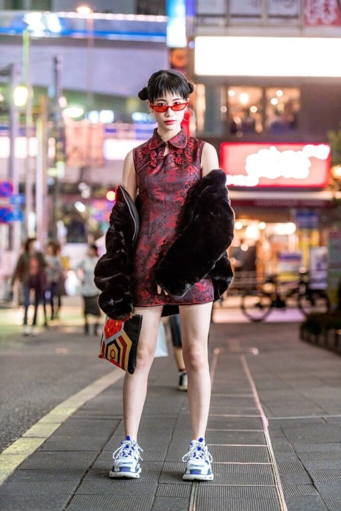 Sleeveless Red Brocade Cheongsam Mini Dress + Oversized Black Faux Fur Coat + Tinted Red Sunglasses + Blue and White Chunky Sneakers