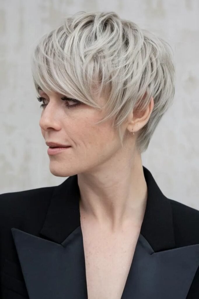 21. Textured Platinum Pixie Cut with Layered Fringe