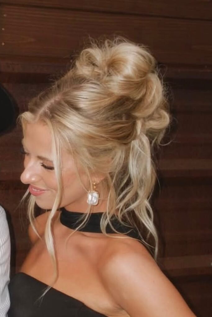 Tousled High Bun with Face-Framing Blonde Layers