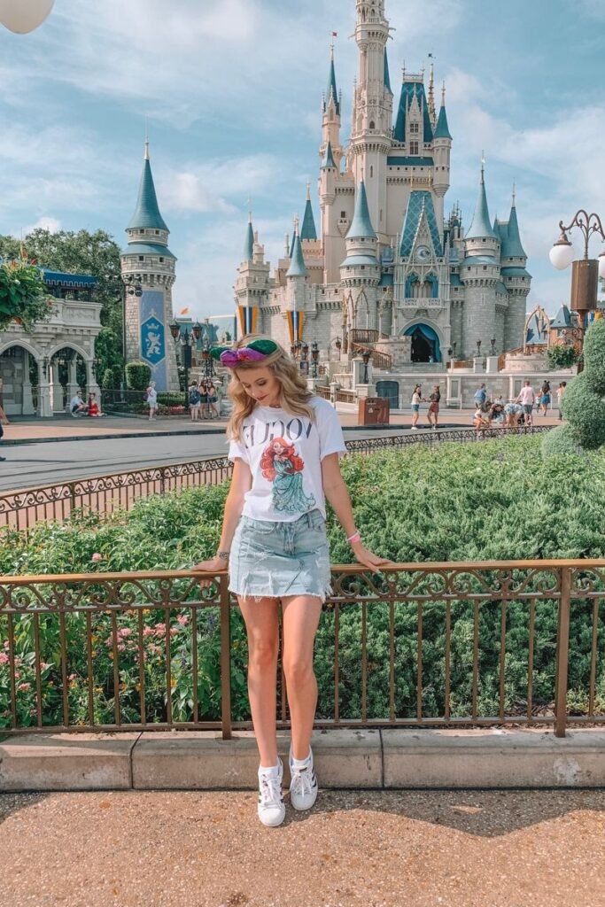 White Ariel Graphic T Shirt + Light Wash Distressed Denim Miniskirt + White Sneakers