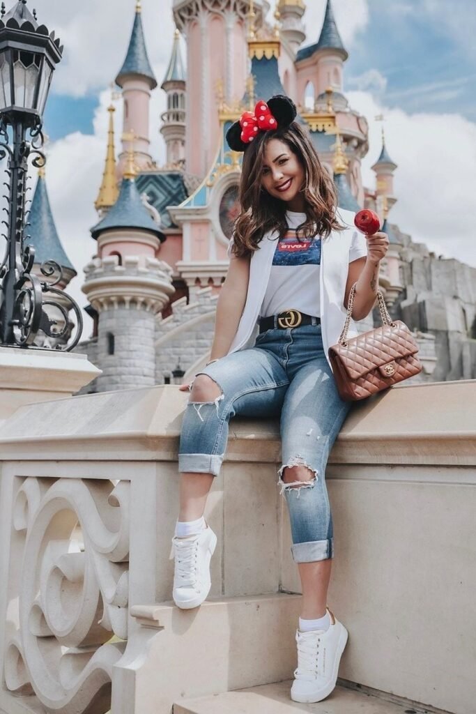 White Graphic T Shirt + Cropped White Vest + Distressed Cuffed Blue Jeans + White Sneakers