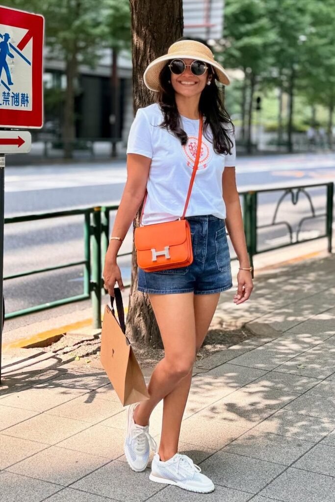 White Graphic T Shirt + Dark Denim Shorts + White Athletic Sneakers