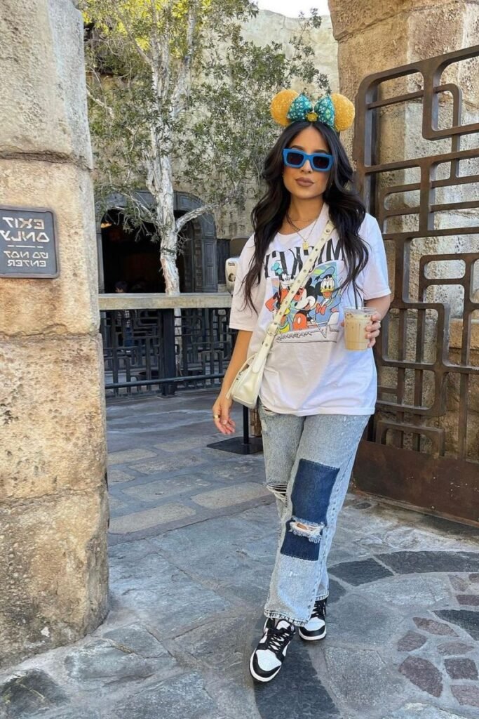 White Graphic T Shirt + Patchwork Distressed Jeans + Black and White Sneakers
