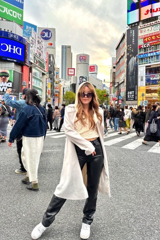 White Hooded Trench Coat + Beige Wrapped Top + Black Leather Pants + White Sneakers