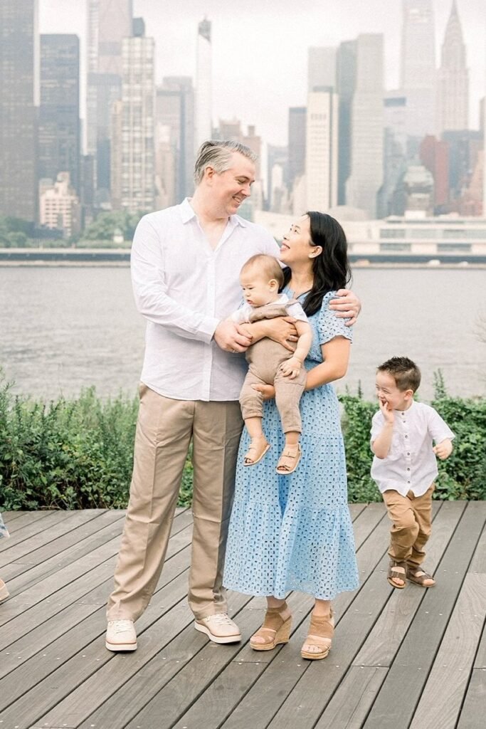 White Long Sleeve Button Down Shirt + Khaki Pants + White Sneakers (Father) / Light Blue Eyelet Dress + Tan Wedge Sandals (Mother) / Tan Romper + Tan Sandals (Baby) / White Short Sleeve Button Down Shirt + Brown Pants + Brown Sandals (Son)