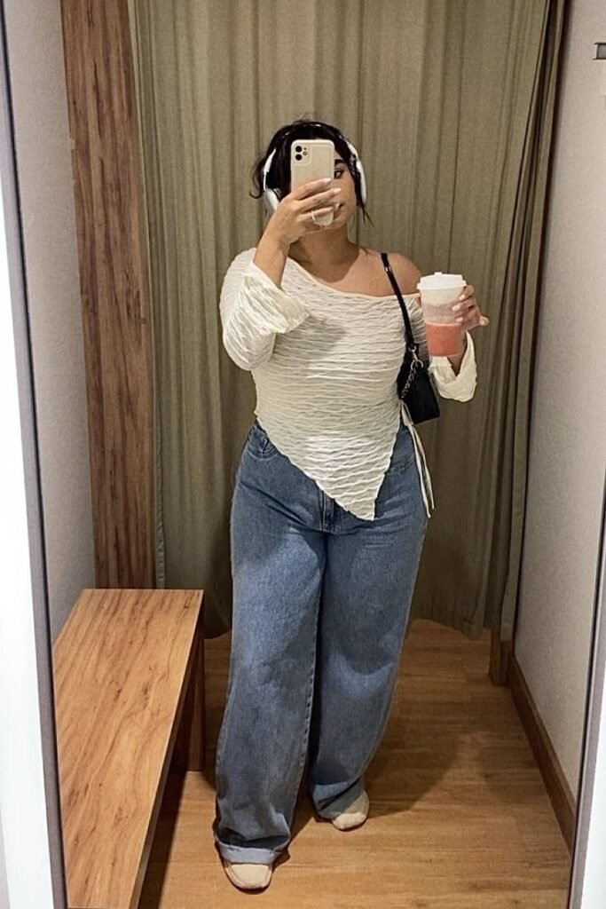 White One Shoulder Asymmetrical Top + Medium Wash Wide Leg Jeans + Beige Sneakers