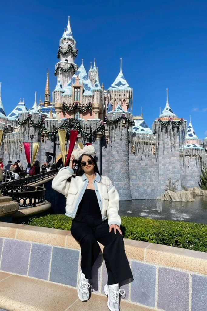 White Shearling Jacket with Denim Trim + Black Crew Neck Top + Black Wide Leg Pants + White Fuzzy Disney Ears Headband + White Sneakers