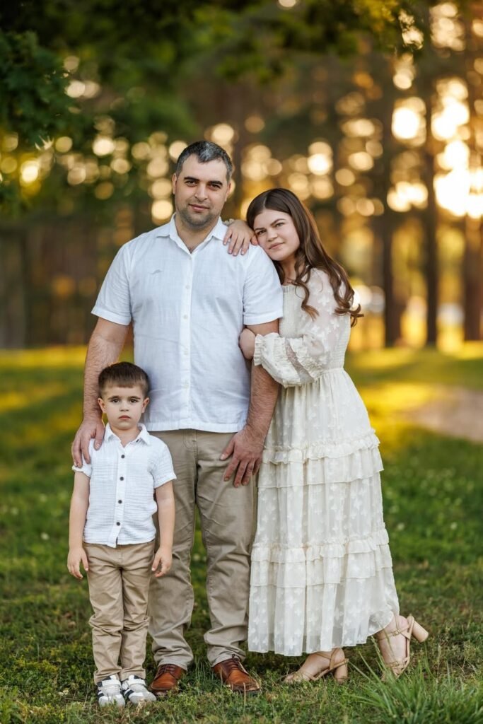 White Short Sleeve Button Down Shirt + Khaki Pants + Brown Shoes (Father) / Cream Tiered Lace Dress + Tan Block Heels (Daughter) / White Short Sleeve Button Down Shirt + Khaki Pants + White Sneakers (Son)