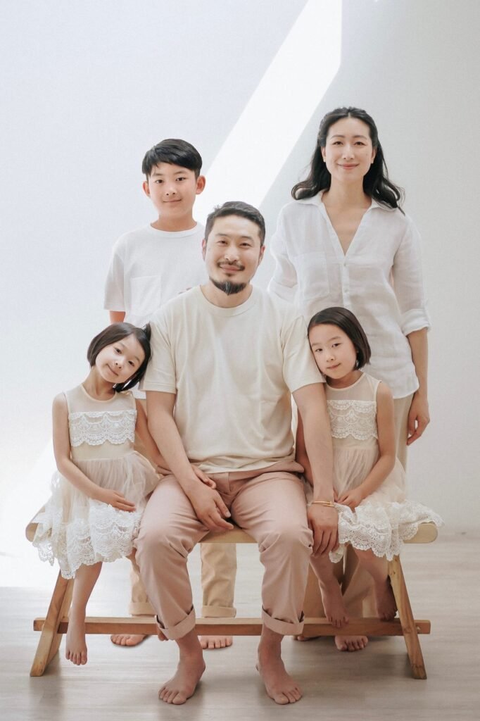 White Short Sleeve Shirt + Khaki Pants (Son) / White Short Sleeve Tee + Tan Pants + Barefoot (Father) / White Button Down Shirt + Tan Pants (Mother) / White Sleeveless Lace Dress + Barefoot (Daughter) / White Sleeveless Lace Dress + Barefoot (Daughter)