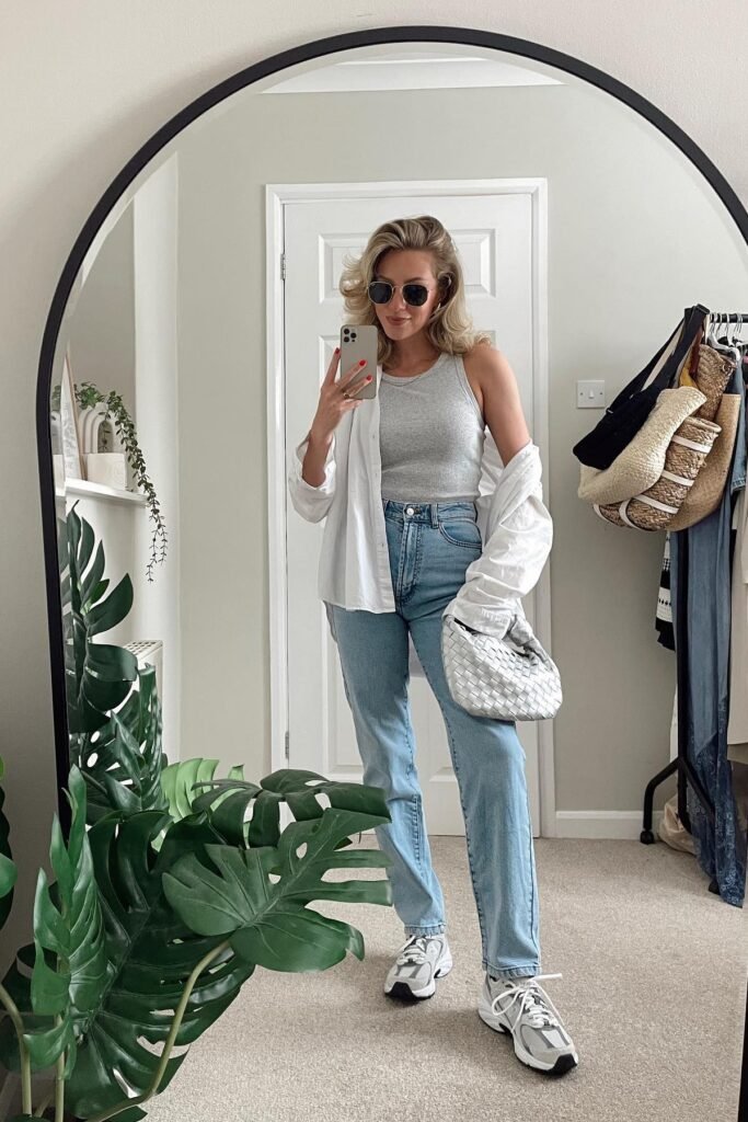 White Unbuttoned Shirt + Grey High Neck Tank Top + Light Wash Straight Jeans + White Athletic Sneakers