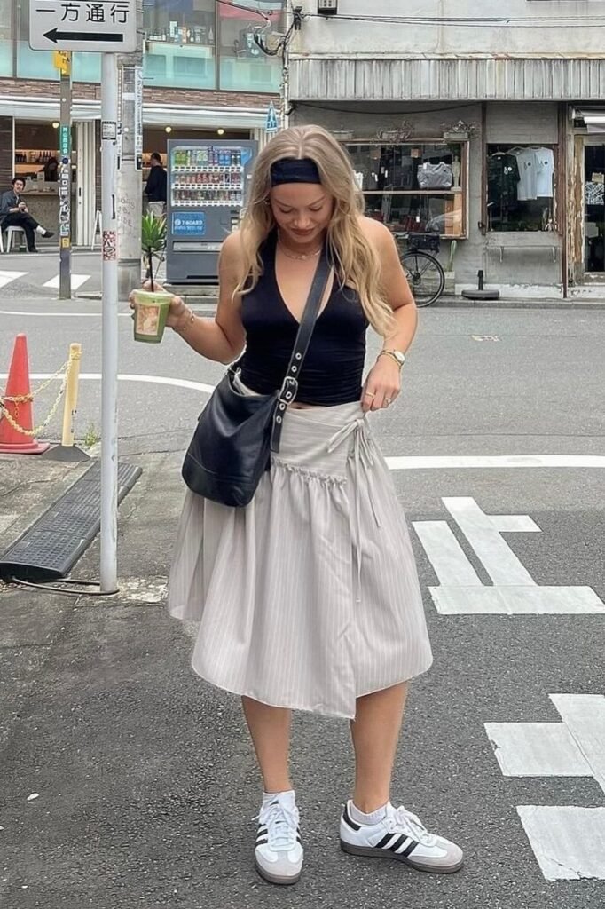 Black Sleeveless Bodysuit + Striped Wrap Skirt + White Sneakers