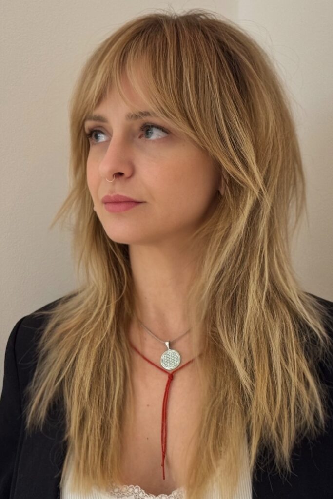 34. Golden Blonde Shag with Wispy Bangs