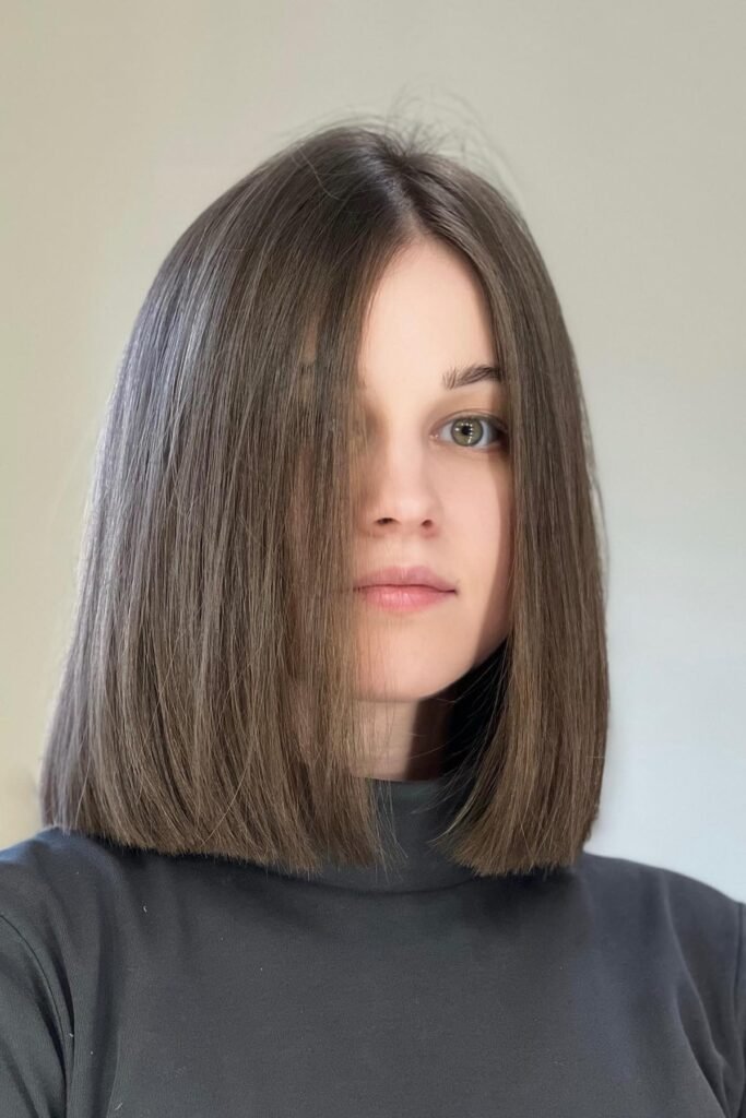 Straight Shoulder-Length Cut with Center Part