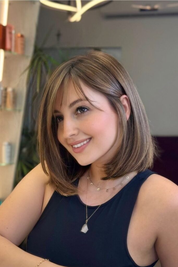 32. Textured Medium-Length Hair with Soft Bangs