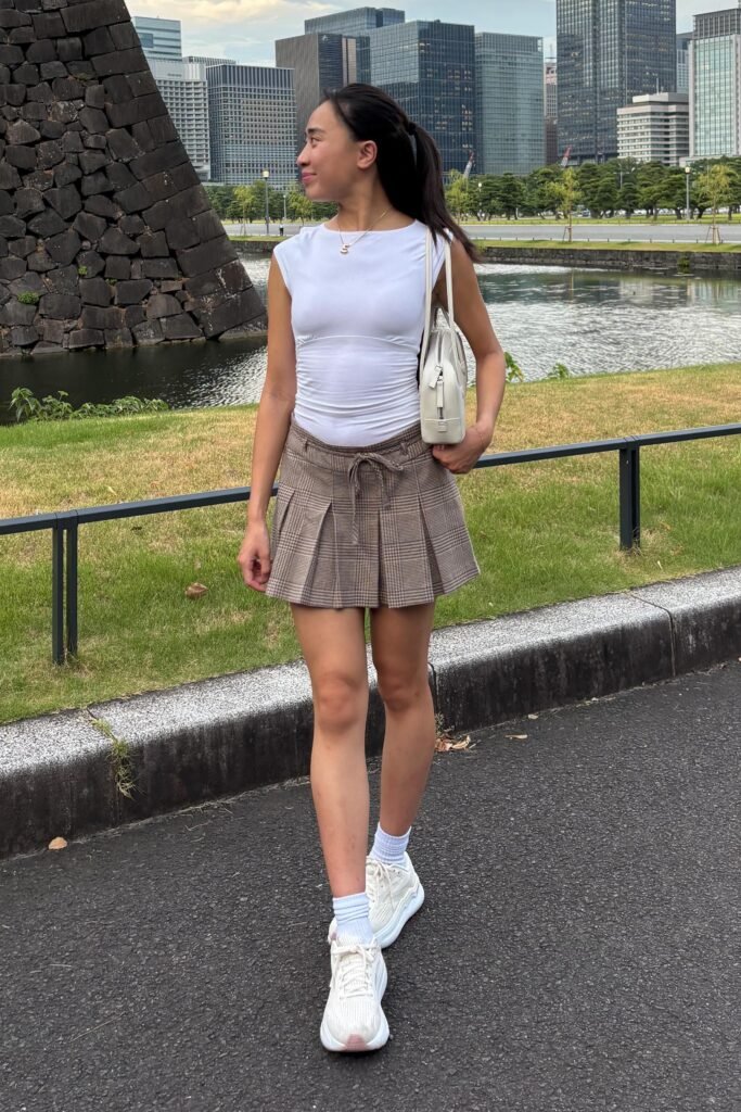 White Sleeveless Top + Plaid Pleated Skirt + White Sneakers