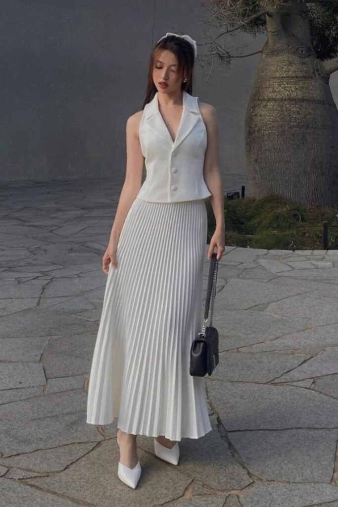 White Sleeveless Vest + White Pleated Maxi Skirt + White Heels + Black Shoulder Bag