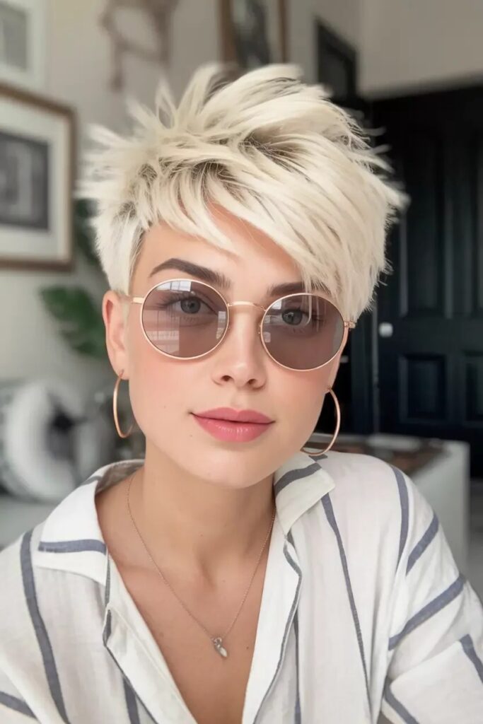 Spiky Blonde Pixie Cut with Forward-Swept Texture and Striped Top