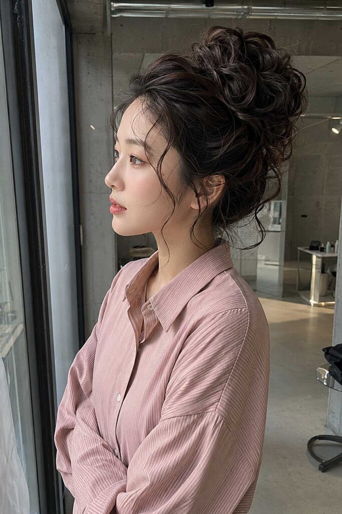 Textured High Messy Bun with Soft Wispy Bangs