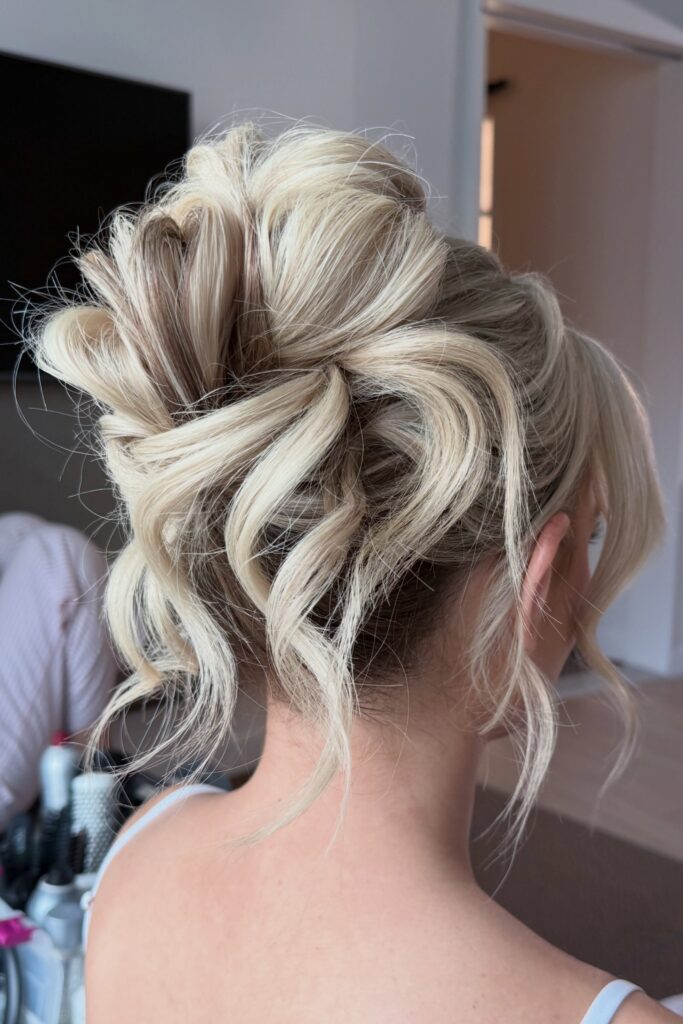 Tousled Blonde Updo with Loose Curly Pieces