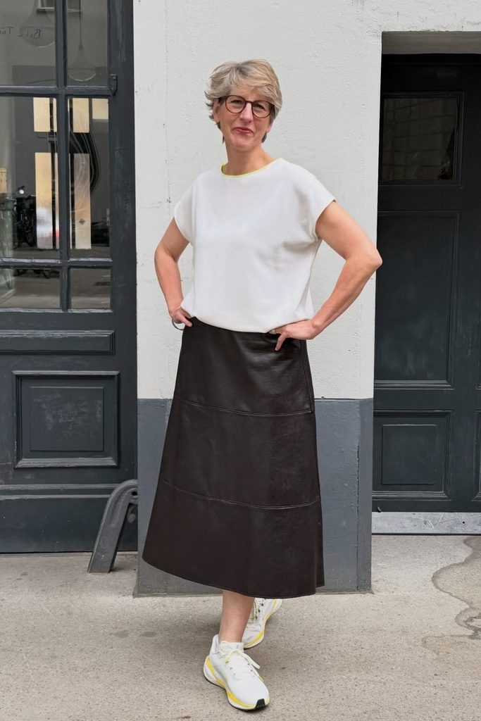 A relaxed boxy tee balances a structured leather midi skirt for easy everyday edge.
