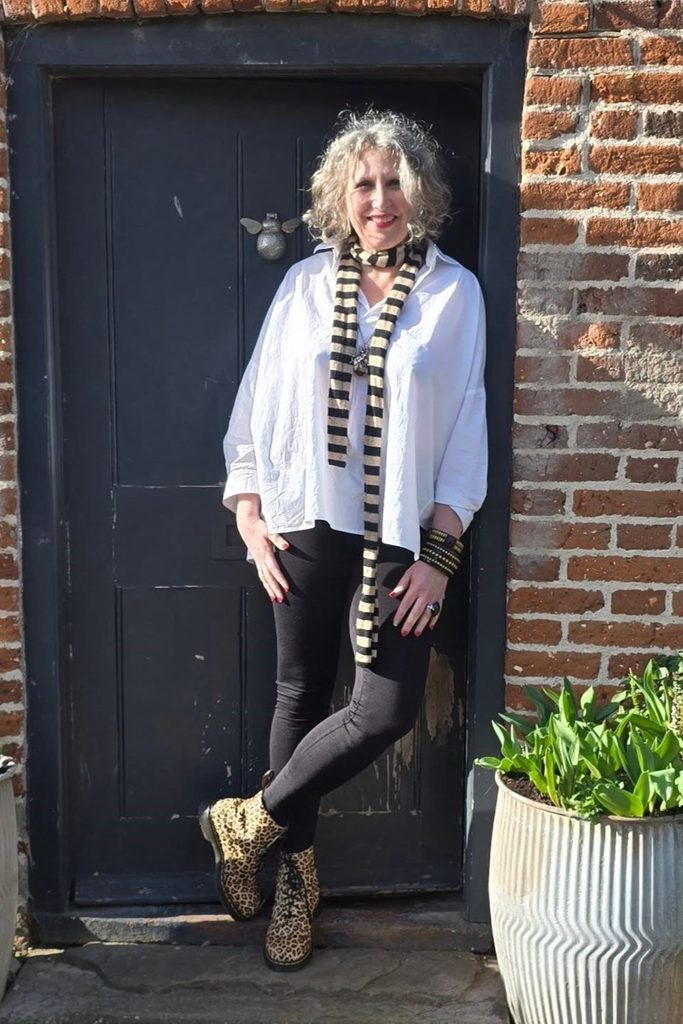 An oversized white shirt and striped scarf let leopard combat boots steal the show.